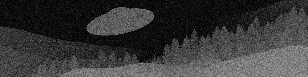 Grainy black and white image of a UAP hovering above the wilderness