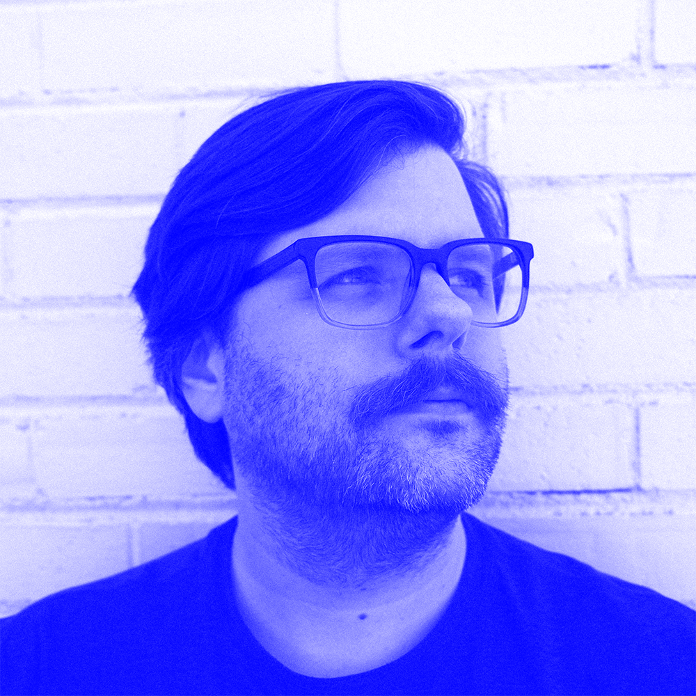 Blue colored headshot of Chris Phillips